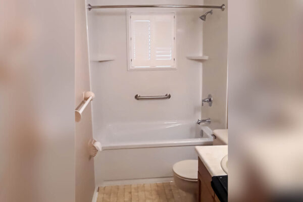 Acrylic tub with acrylic enclosure surrounding the walls and ceiling after tub remodeling and tub replacement.